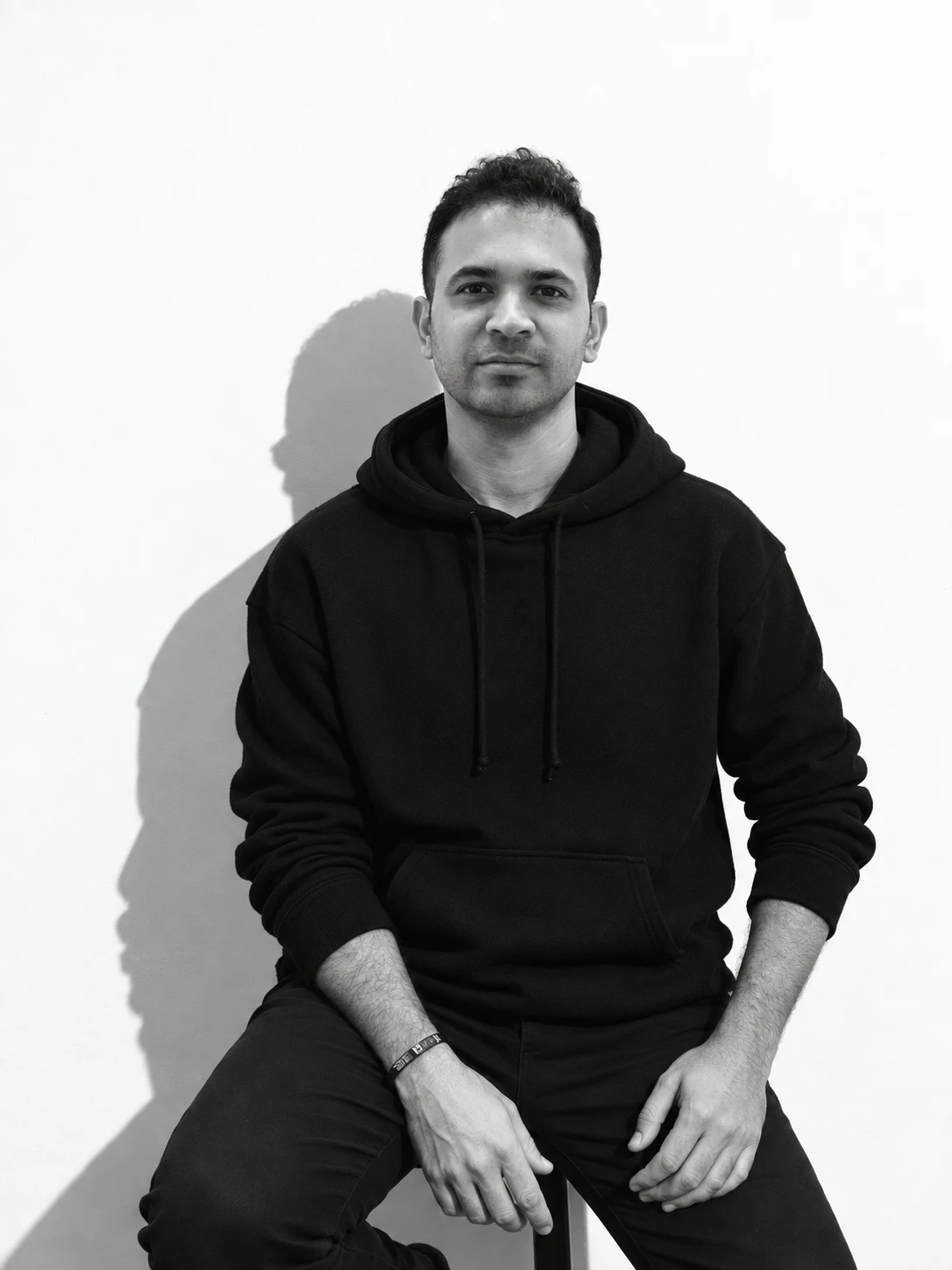 Vinay Sagar Deekonda, the maker of Raxha, in a black-and-white seated portrait.